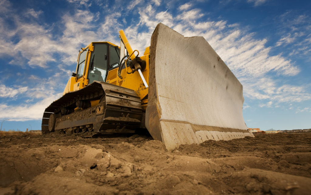 yellow bulldozer equipped with blade and LED lights